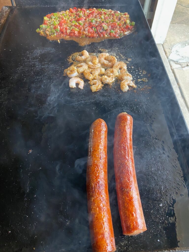 cajun dogs and toppings on griddle